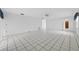 Large living area features tile floors and several entryways, with lots of bright sunlight at 830 Hawkes Ave, Orlando, FL 32809