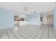 Bright living space with tiled flooring, a partial view of the kitchen and a ceiling fan at 830 Hawkes Ave, Orlando, FL 32809
