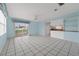 Bright living space with tiled flooring, a ceiling fan, and a sliding glass door at 830 Hawkes Ave, Orlando, FL 32809