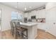 Modern kitchen featuring white cabinets, stainless steel appliances, and a center island with seating at 9027 Coral Cape St, Kissimmee, FL 34747