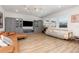 Bright living room with blonde wood floors, grey built-ins, comfortable seating, and a view of the backyard at 9027 Coral Cape St, Kissimmee, FL 34747