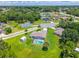 Aerial view of home showcasing the backyard's screened-in pool, storage shed, grassy lawn and lovely neighborhood at 909 Hendon Place, Kissimmee, FL 34758