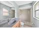 Bright bathroom with decorative shower, granite vanity, and neutral color palette at 909 Hendon Place, Kissimmee, FL 34758