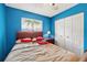 Bright bedroom featuring a large window, a ceiling fan and a spacious closet at 909 Hendon Place, Kissimmee, FL 34758