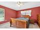 Spacious bedroom with a ceiling fan, large window, and rich red walls at 909 Hendon Place, Kissimmee, FL 34758