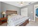 Cozy bedroom featuring a ceiling fan, closet and a wood bed frame with a decorative quilt at 909 Hendon Place, Kissimmee, FL 34758