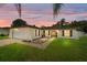 Charming single-story home with a well-manicured lawn, lovely sunset and attached garage at 909 Hendon Place, Kissimmee, FL 34758