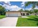 Well-maintained single-story home with attached garage and inviting front yard at 909 Hendon Place, Kissimmee, FL 34758