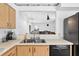 Bright kitchen featuring wood cabinets, black appliances and view of dining room at 909 Hendon Place, Kissimmee, FL 34758