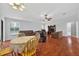 Open-concept living area with wood floors, ceiling fan, and ample seating at 909 Hendon Place, Kissimmee, FL 34758