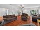 Bright and airy living room with wood floors and a smooth transition to the dining area at 909 Hendon Place, Kissimmee, FL 34758
