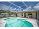 Inviting screened-in pool area, with grill, table, and lounge chairs, perfect for relaxation at 909 Hendon Place, Kissimmee, FL 34758