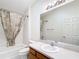 Bright bathroom with a shower, vanity, large mirror, and tile flooring at 1008 Jackson St, The Villages, FL 32162