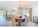 Inviting dining area with chandelier, and open flow to the comfortable and bright living room at 1008 Jackson St, The Villages, FL 32162