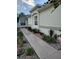 Charming single-story home featuring a well-maintained yard with lush landscaping and a welcoming walkway at 1008 Jackson St, The Villages, FL 32162
