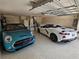 Well-organized garage showcases two stylish cars, ample storage, and epoxy flooring for a clean, modern look at 1008 Jackson St, The Villages, FL 32162