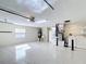 Spacious garage features epoxy flooring, storage space, and efficient utility systems in a well-lit area at 1008 Jackson St, The Villages, FL 32162