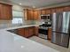 Updated kitchen featuring stainless steel appliances and light countertops at 1008 Jackson St, The Villages, FL 32162