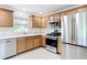 Bright kitchen with modern appliances, light wood cabinets, and a convenient layout for cooking and entertaining at 1008 Jackson St, The Villages, FL 32162