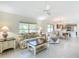 Cozy living room featuring neutral tones, tile flooring, and an open layout perfect for relaxing and entertaining guests at 1008 Jackson St, The Villages, FL 32162
