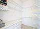 Spacious walk-in closet offers ample storage with shelving and drawers at 1008 Jackson St, The Villages, FL 32162