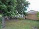Lush backyard featuring mature trees and landscaping at 1021 Golfside Ct, Kissimmee, FL 34741
