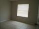 Neutral bedroom with window offers a blank canvas for personalization at 1021 Golfside Ct, Kissimmee, FL 34741