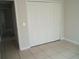 Neutral bedroom with closet and tile flooring creates a blank canvas for customization at 1021 Golfside Ct, Kissimmee, FL 34741