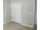 The bedroom features large closet space and light tile flooring at 1021 Golfside Ct, Kissimmee, FL 34741