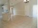 Bright open-concept living area featuring tiled floors, modern chandelier, and adjoining kitchen space at 1021 Golfside Ct, Kissimmee, FL 34741