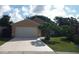 Lovely single-story house featuring a well-maintained lawn, mature tree, and a spacious driveway at 1021 Golfside Ct, Kissimmee, FL 34741