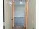 Hallway providing an entry to a bright room with neutral walls at 1021 Golfside Ct, Kissimmee, FL 34741