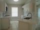 Bright kitchen featuring white cabinets, stainless steel appliances, and a window at 1021 Golfside Ct, Kissimmee, FL 34741