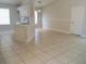 Open living space with tiled floors, modern lighting, and ample natural light from a nearby window at 1021 Golfside Ct, Kissimmee, FL 34741