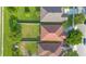 A bird's eye view of the home surrounded by well-kept lawns and greenery at 10580 Moss Rose Way, Orlando, FL 32832