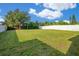Well-maintained backyard with lush green grass and a pristine white fence at 10580 Moss Rose Way, Orlando, FL 32832