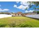Large backyard with lush green grass and a white fence, offering ample space for outdoor activities at 10580 Moss Rose Way, Orlando, FL 32832