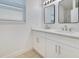 Elegant bathroom with a double sink vanity, modern mirrors, and bright lighting at 10580 Moss Rose Way, Orlando, FL 32832