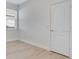 Bright bedroom featuring neutral walls, updated flooring, and a large window for natural light at 10580 Moss Rose Way, Orlando, FL 32832