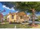 Inviting front exterior showcasing a well-maintained lawn and covered porch at 10580 Moss Rose Way, Orlando, FL 32832