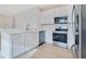 Modern kitchen featuring stainless steel appliances, white cabinets, and quartz countertops at 10580 Moss Rose Way, Orlando, FL 32832