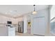 Bright, updated kitchen with stainless steel appliances, white cabinets and an island at 10580 Moss Rose Way, Orlando, FL 32832