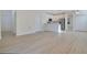 Open-concept living room with updated flooring, kitchen with stainless steel appliances, and plentiful natural light at 10580 Moss Rose Way, Orlando, FL 32832