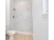 Modern bathroom showcasing a tile shower with new fixtures, and bright natural light at 10580 Moss Rose Way, Orlando, FL 32832