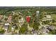 Aerial view of the property within a neighborhood surrounded by mature trees and water tower at 1130 Burland Cir, Winter Garden, FL 34787