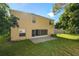 Back of the home showcases a spacious patio and a sizable backyard with verdant landscaping at 1130 Burland Cir, Winter Garden, FL 34787