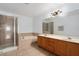 Bathroom featuring double vanity, tub, and a glass-enclosed shower at 1130 Burland Cir, Winter Garden, FL 34787