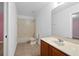 Neutral bathroom features tile flooring, tub with shower, and a vanity sink with ample lighting at 1130 Burland Cir, Winter Garden, FL 34787
