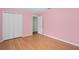 A bright bedroom featuring laminate floors and a closet at 1130 Burland Cir, Winter Garden, FL 34787