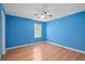 Clean bedroom with a ceiling fan, wood floors, natural light, and blue walls at 1130 Burland Cir, Winter Garden, FL 34787